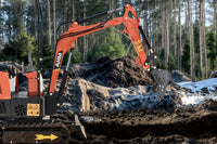 A mini excavator with a long bucket arm for trench digging